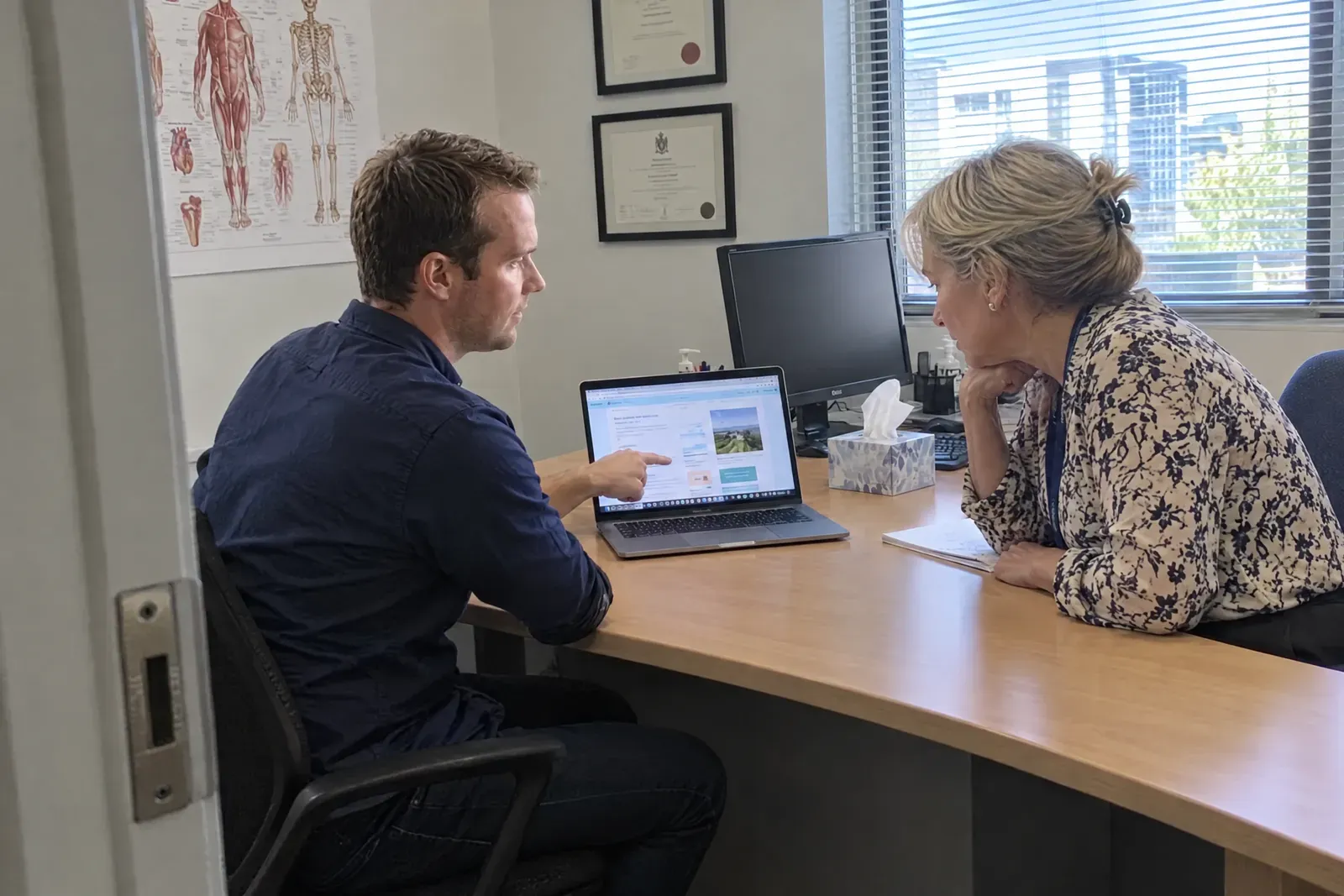 Dru showing a new practice website to a specialist in her consulting room